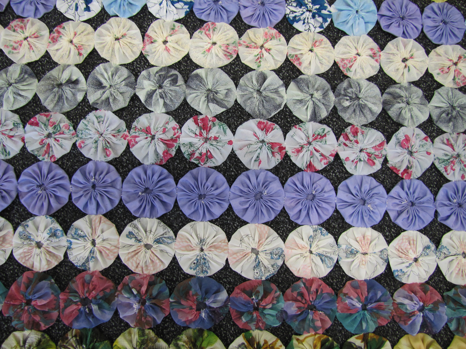 Photographs of quilt made from fabric circles - Open Access Repository